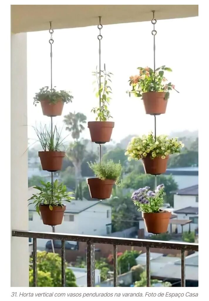Horta vertical com vasos suspensos na varanda, aproveitando pequenos espaços para cultivo de temperos e flores.